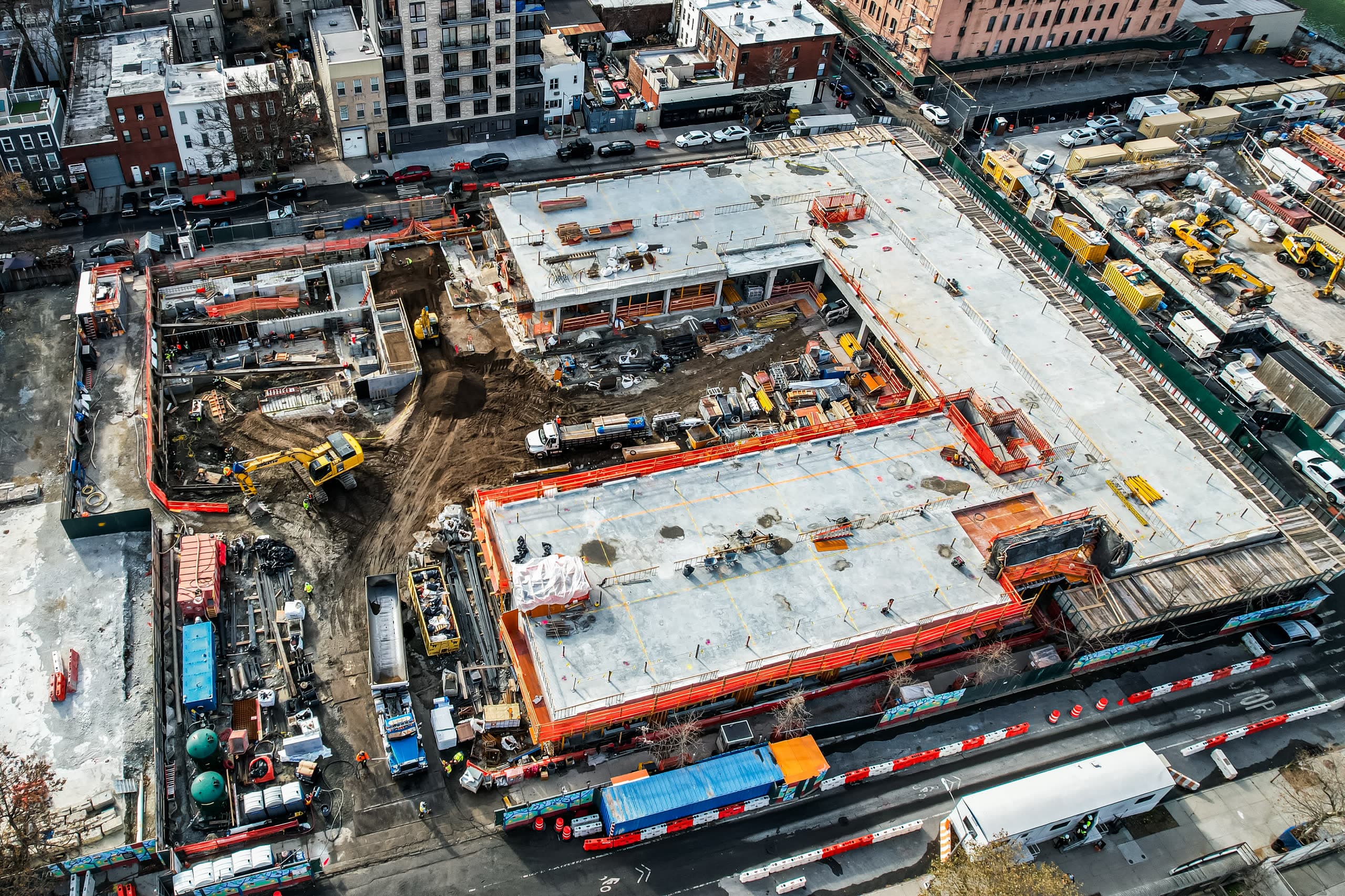 Aerial view of an active Metro Erectors jobsite with a podium deck under construction